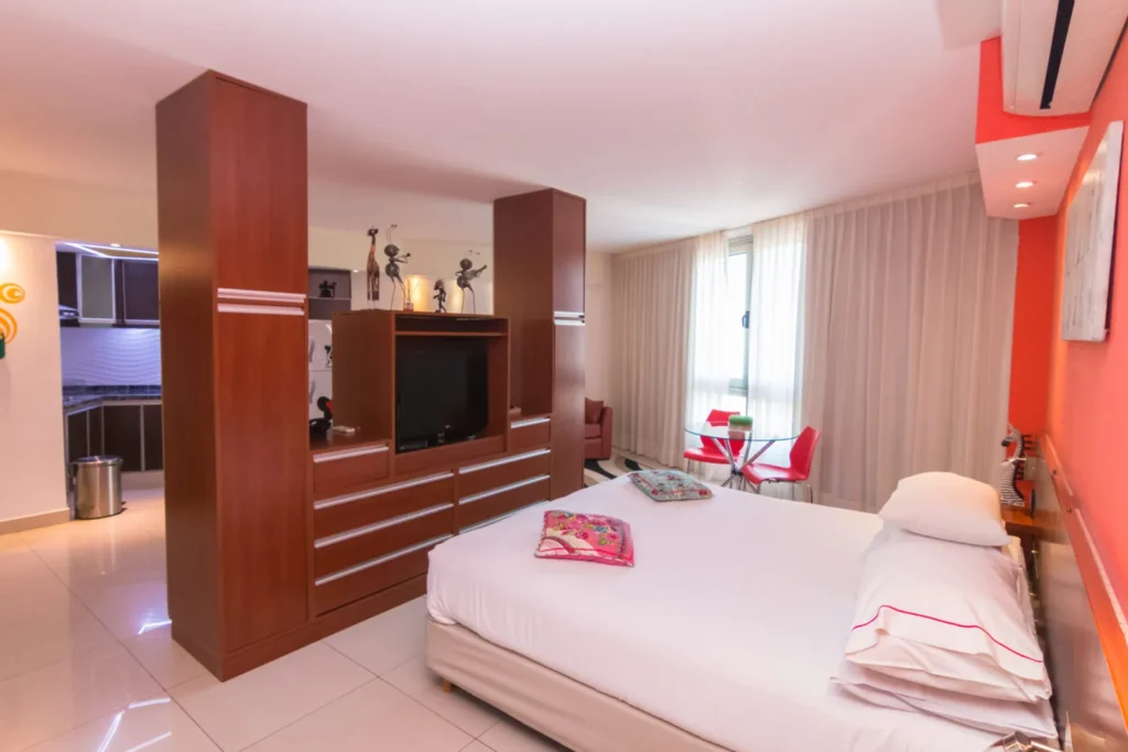 Superior Room with bed and wooden divider with TV