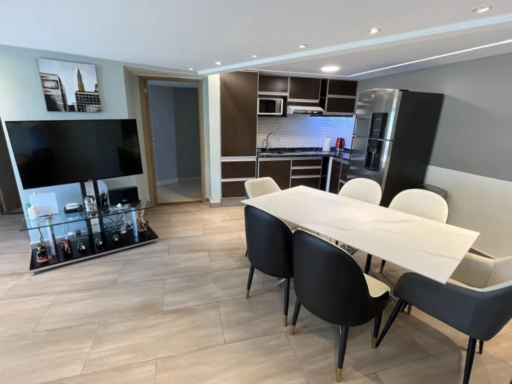Shoshana Suite dining area with white table and integrated kitchen