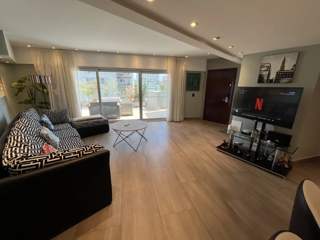 Shoshana Suite living room with armchair, TV and large window